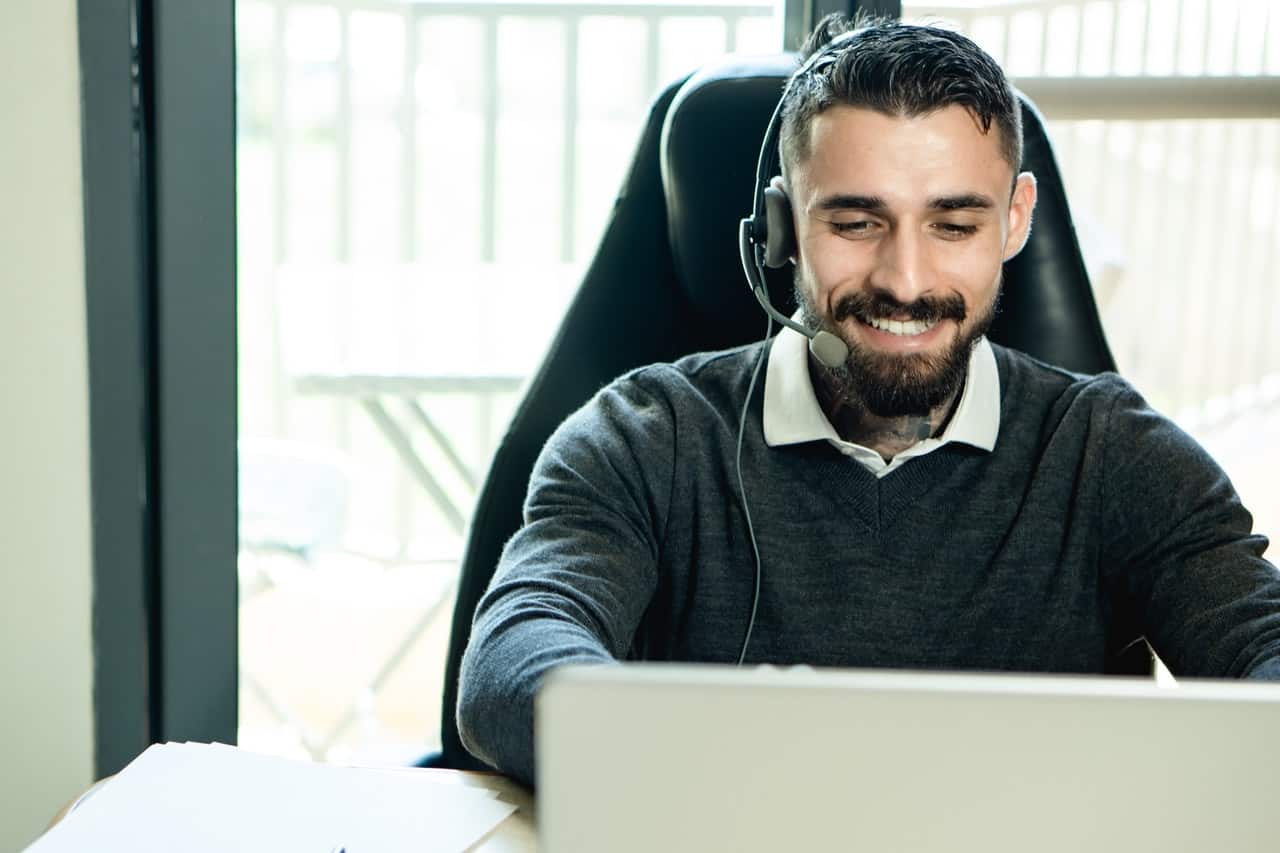 Male in black sweater using a customer service management platform